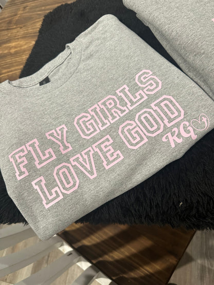 Gray sweatshirt with pink text on a wooden surface